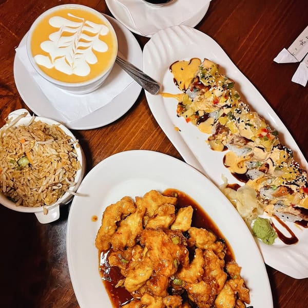 A J Liu of Dublin Asian-fusion meal with soup, fried rice, orange chicken, and sushi rolls.